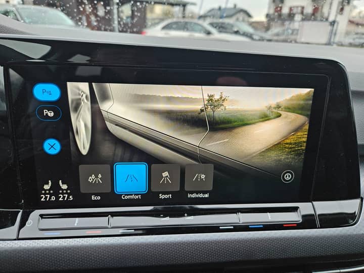 Slika prikazuje unutrašnjost vozila s infotainment zaslonom.