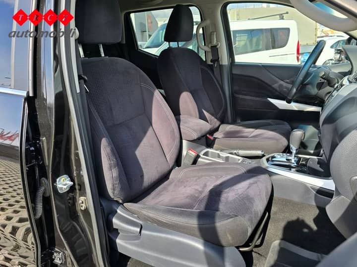 Slika prikazuje unutrašnjost vozila, fokus na sjedala i upravljač.