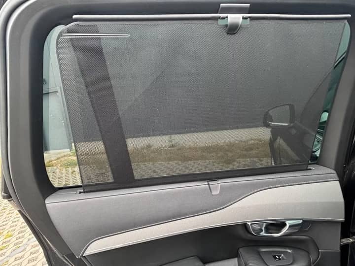 Slika prikazuje unutrašnjost vozila, panel vrata i prozor.