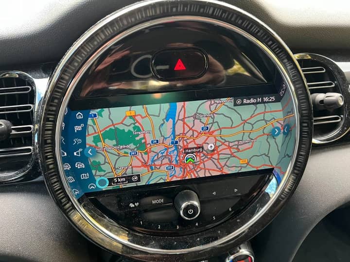 Slika prikazuje unutrašnjost vozila s navigacijskim zaslonom.