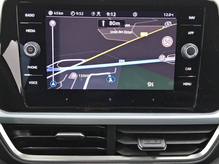 Slika prikazuje unutrašnjost vozila s navigacijskim zaslonom.