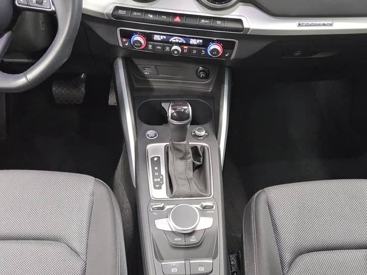 Slika prikazuje unutrašnjost vozila, središnja konzola i panel.