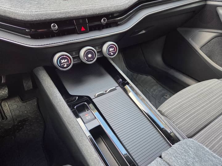Slika prikazuje unutrašnjost vozila, fokus na središnjoj konzoli i instrumentnoj ploči.