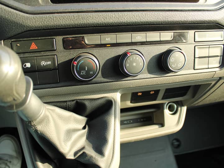 Slika prikazuje unutrašnjost vozila (panel kontrole i klima).